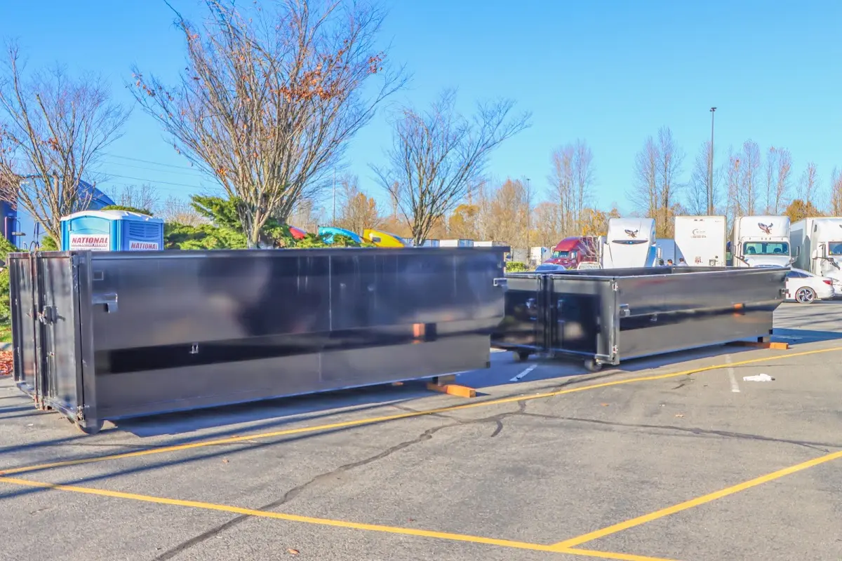 Professional dumpster rental service with roll-off container on residential driveway in Nampa